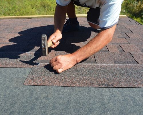 contractor hammering shingles contractor hammering shingles