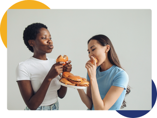 Two friends eating burgers