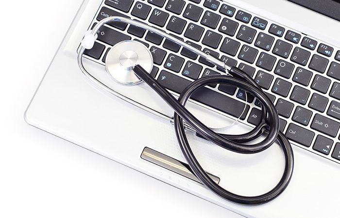 laptop with stethoscope on the keyboard