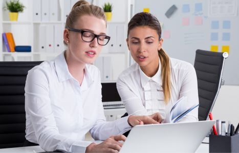 two woman at laptop