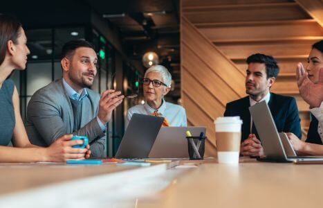 coworkers at table discussing work