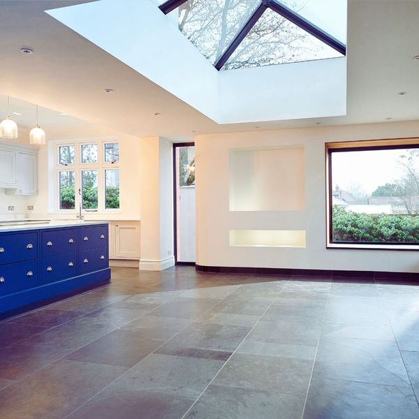 large room with tile floor and skylight