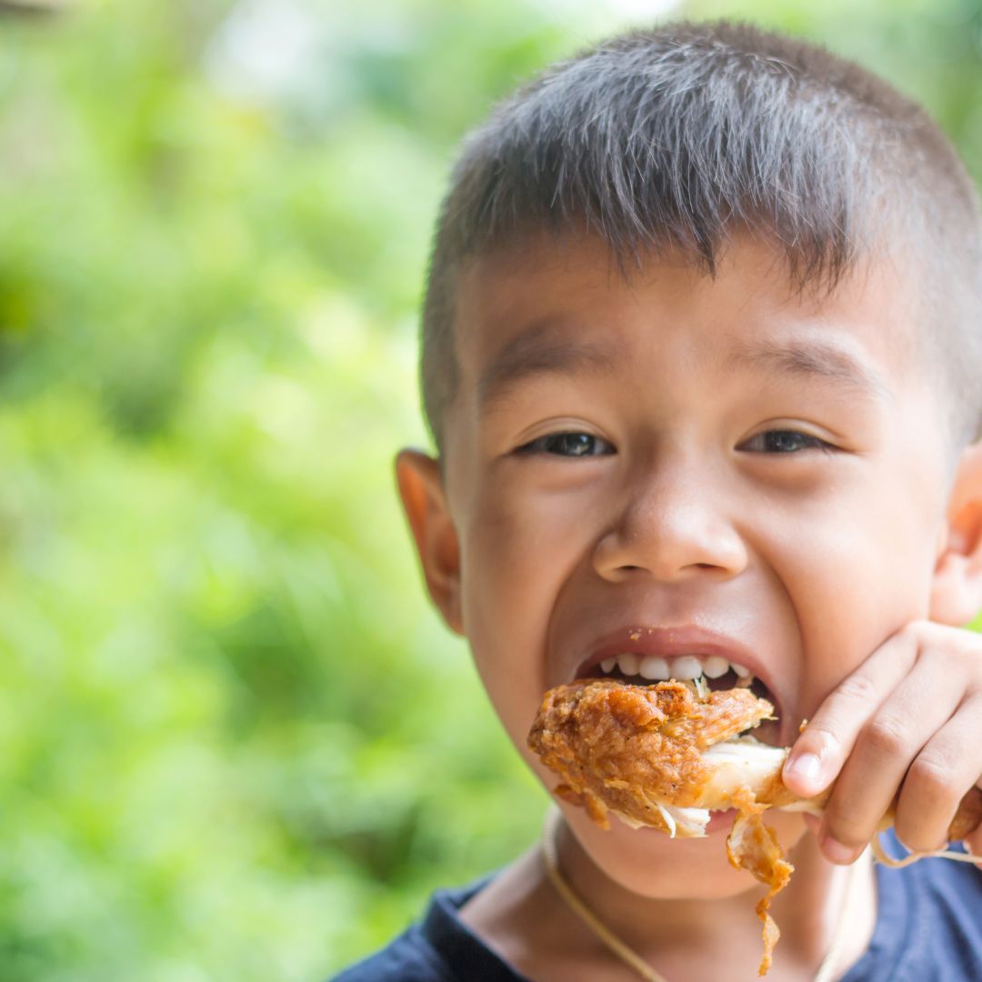 kid eating chicken 
