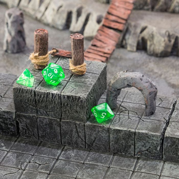 D&D dice on a miniature set with a rope bridge