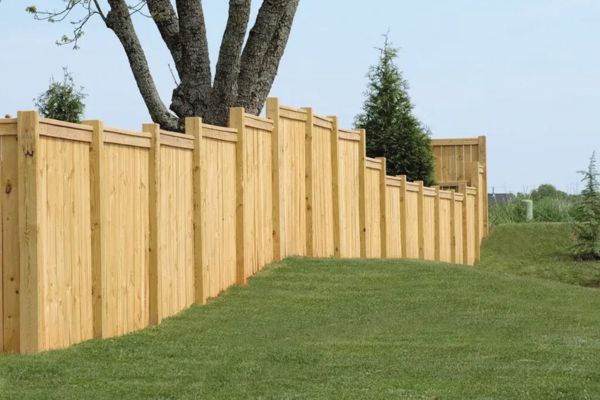 new wood fence in green yard