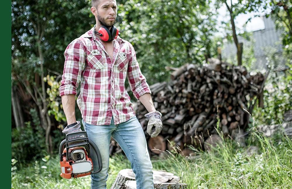 Man with chainsaw and ear protection