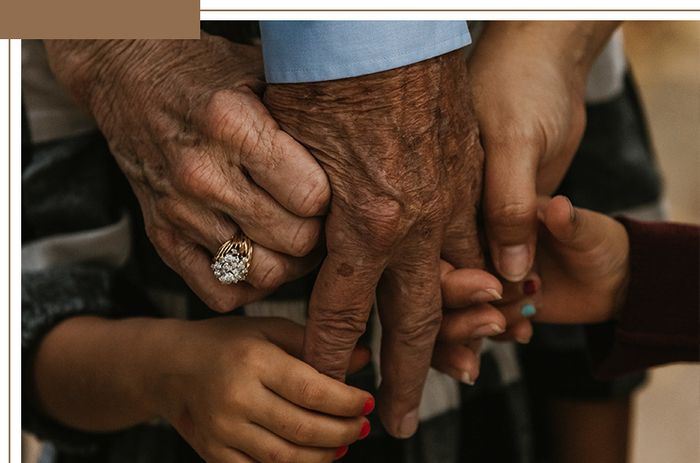 family holding elder's hand
