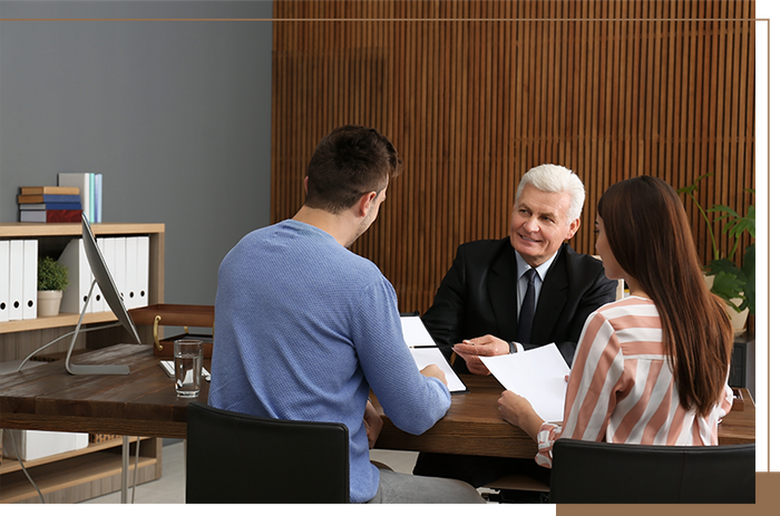 a young couple talking with a lawyer