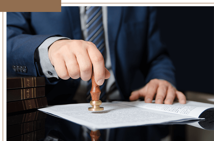 a lawyer stamping paperwork with a seal