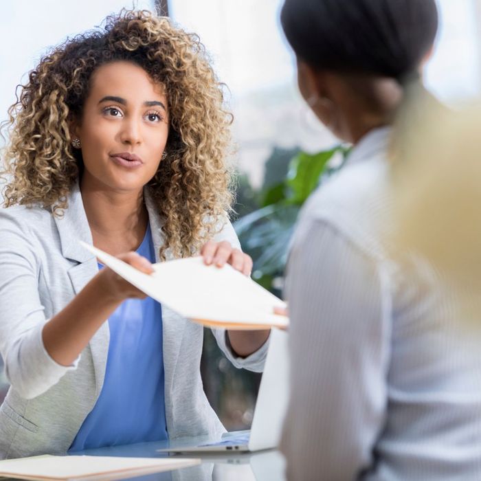 therapist handing over paperwork