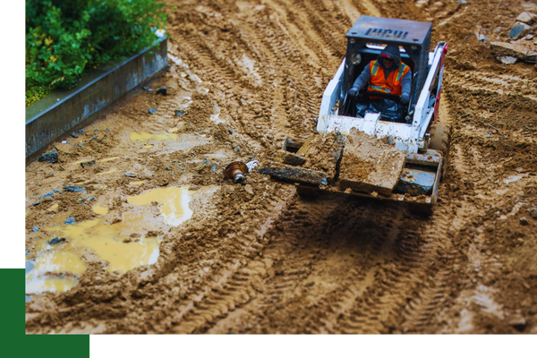 a person drives a bobcat on a land clearing project demo 3 (2).png