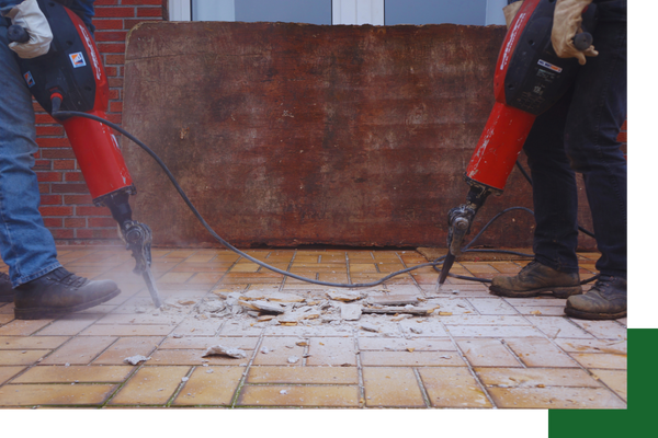 workers using jackhammers to remove concrete and bricks demo 2.png