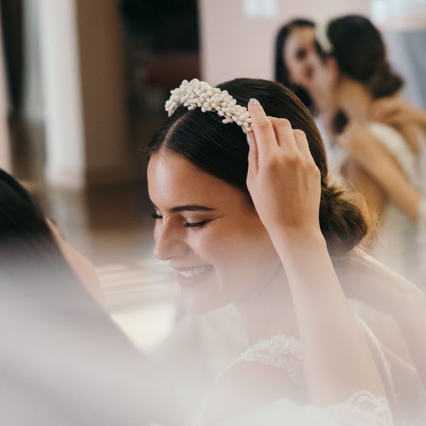 a smiling bride, happily getting ready for her wedding day