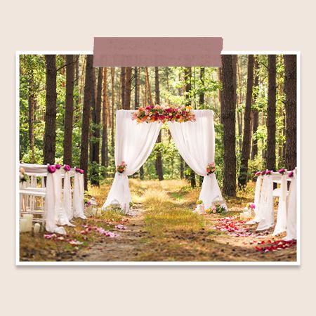 a wedding arch decorated with drapes and flowers
