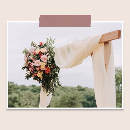 wedding arch drapery with flower accents