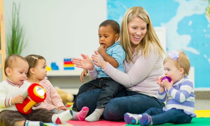 kids playing at a daycare with caregiver