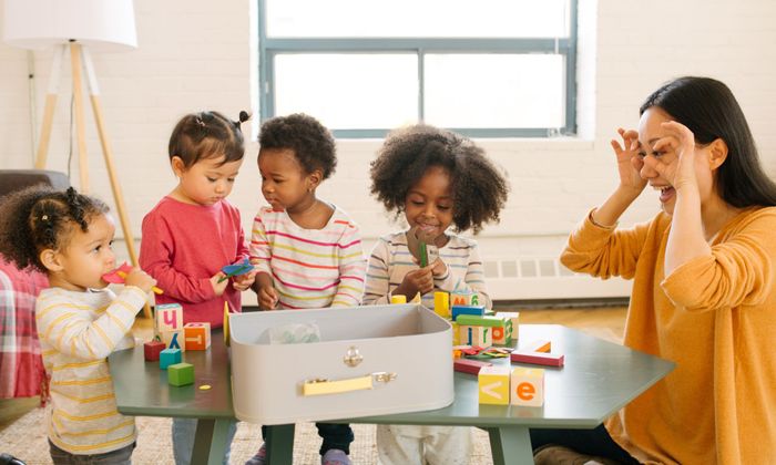 kids playing at a daycare with caregiver