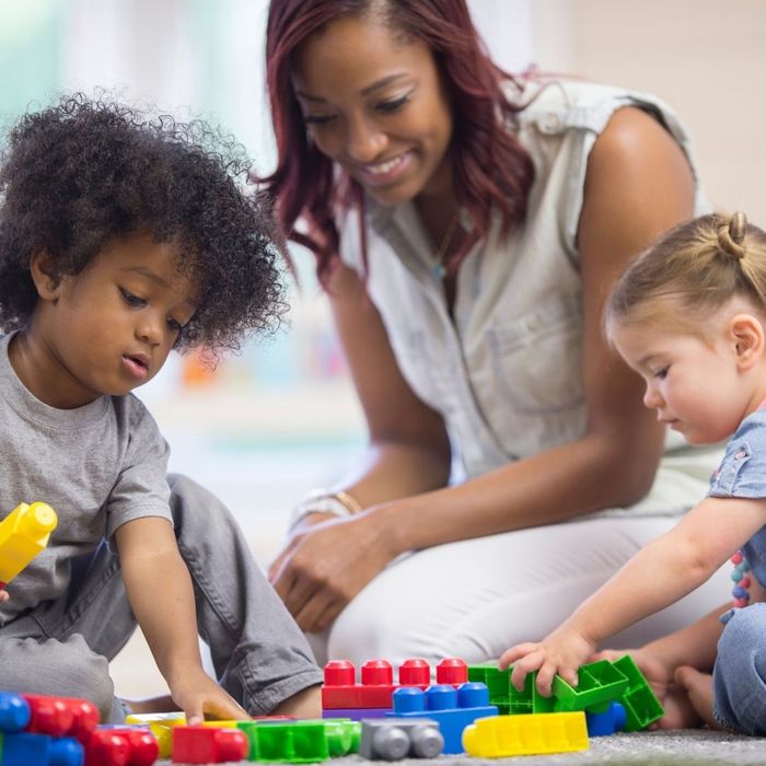 teacher building legos with students