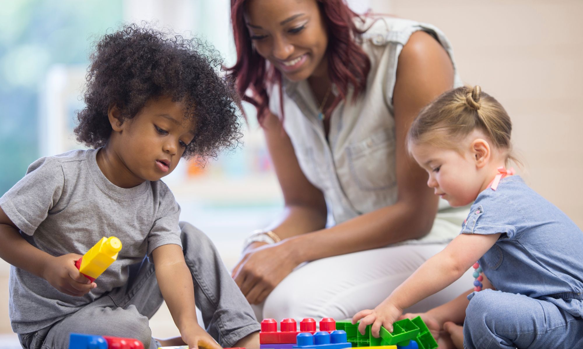 kids playing at a daycare with caregiver