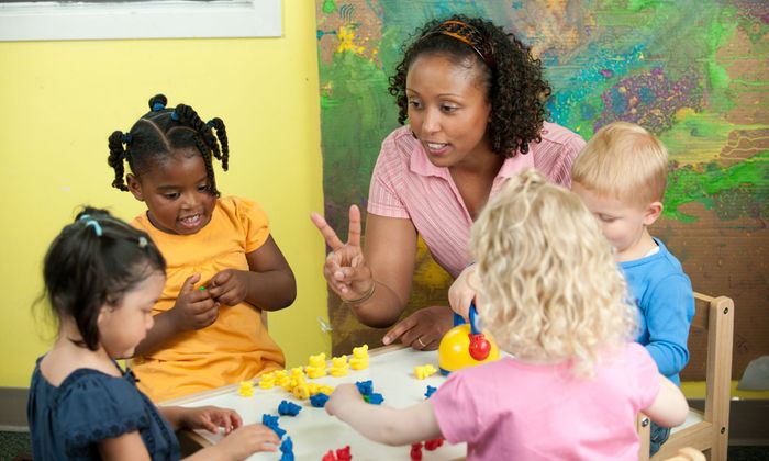 kids learning at a daycare with caregiver