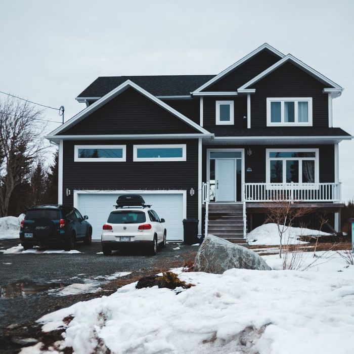 house with cars parked in front of the garage
