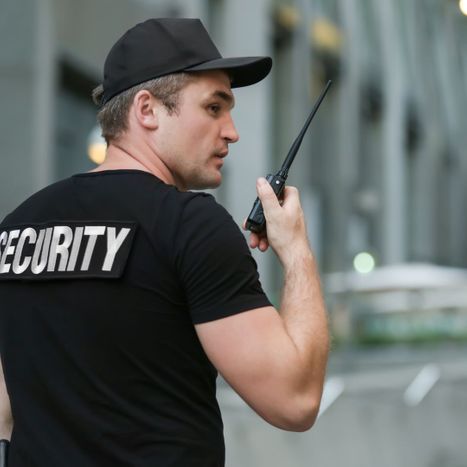 Security worker talking on walkie talkie