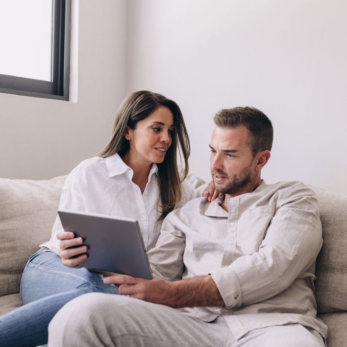 husband and wife budgeting on a computer