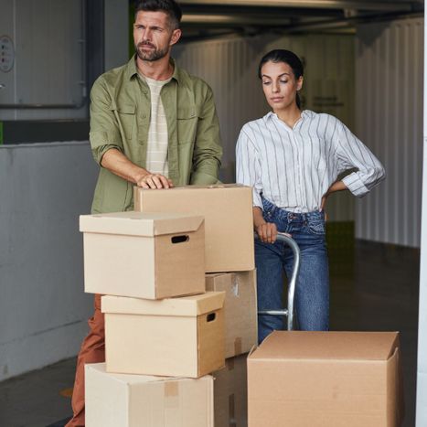 A couple standing in front of boxes at a storage facility