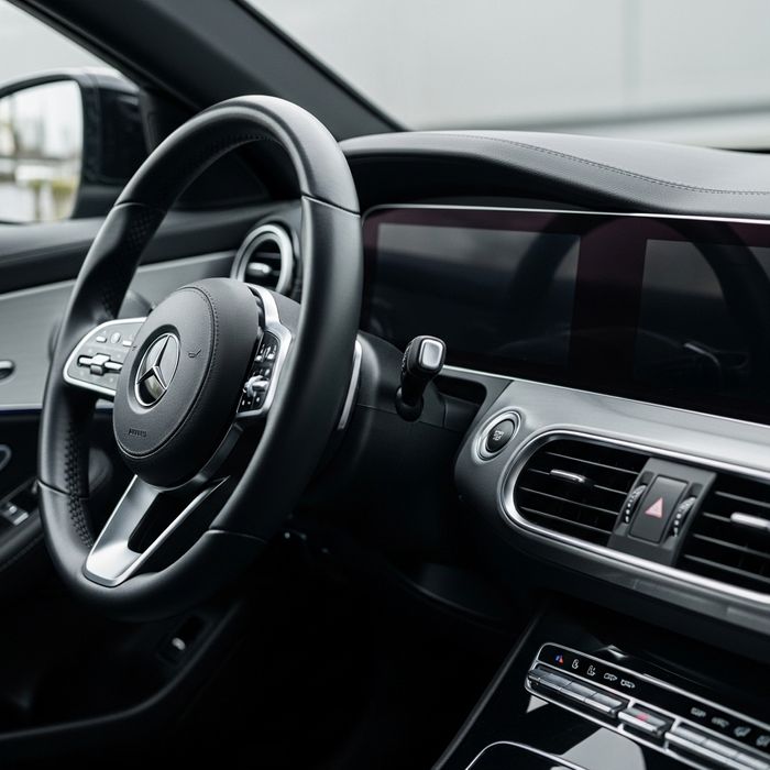 Close-up of a meticulously clean, dust-free car dashboard and steering wheel.