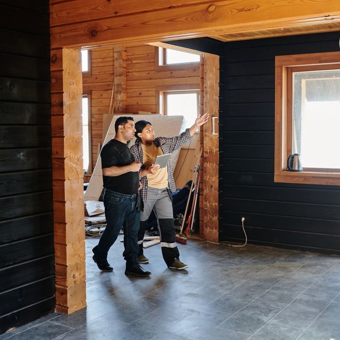 contractors walking through remodeling project with no furniture in home