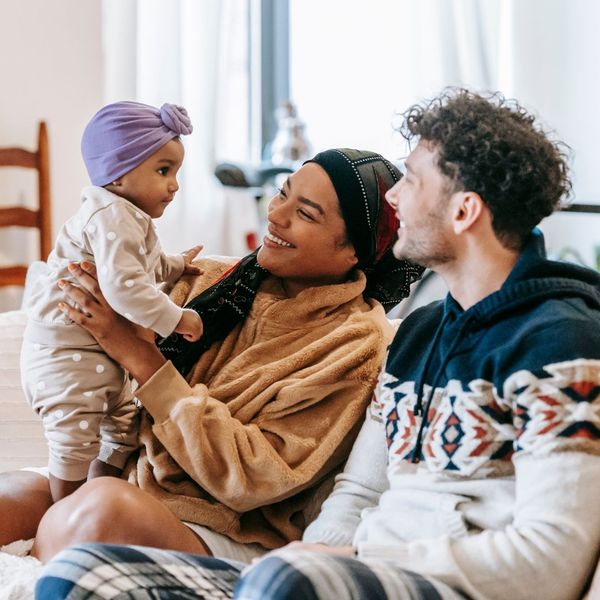 Parents holding their children.