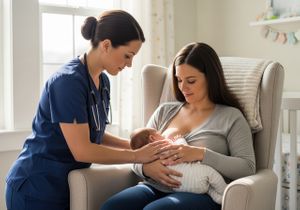 Mother breastfeeding with nurse support