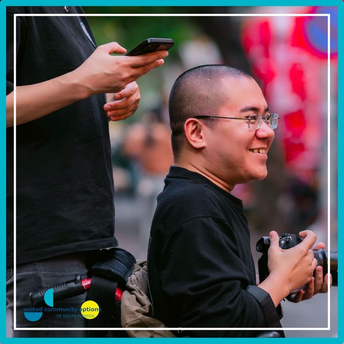 a man smiling and taking photos How Supported Living Enhances Independence (3).jpg