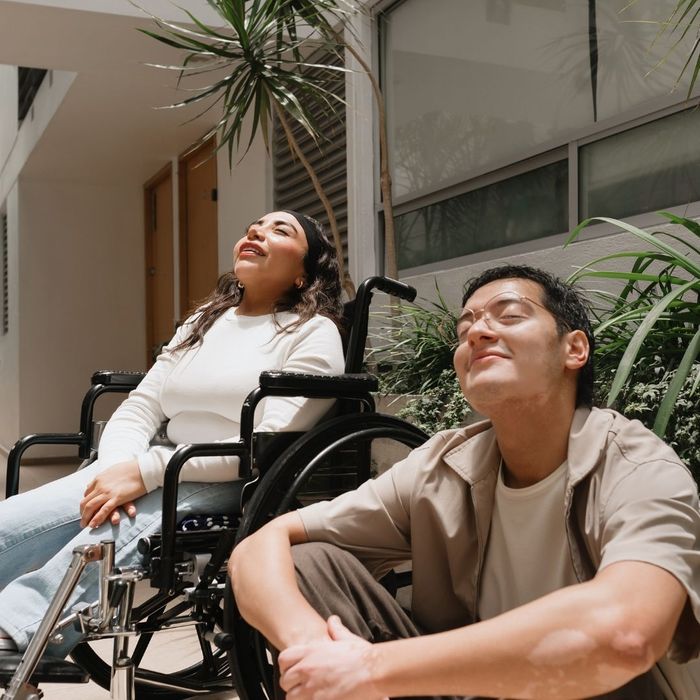 happy and relaxed man and woman in wheelchair