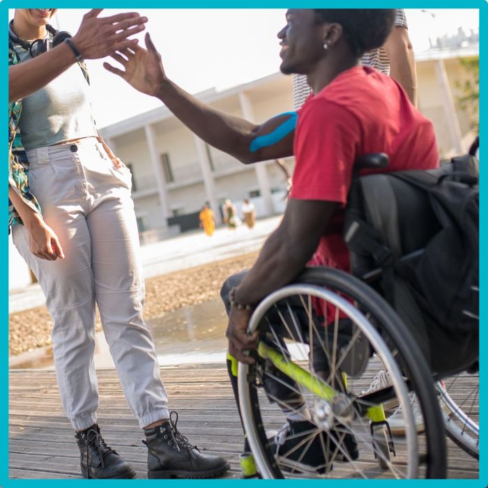 man in wheelchair with friends