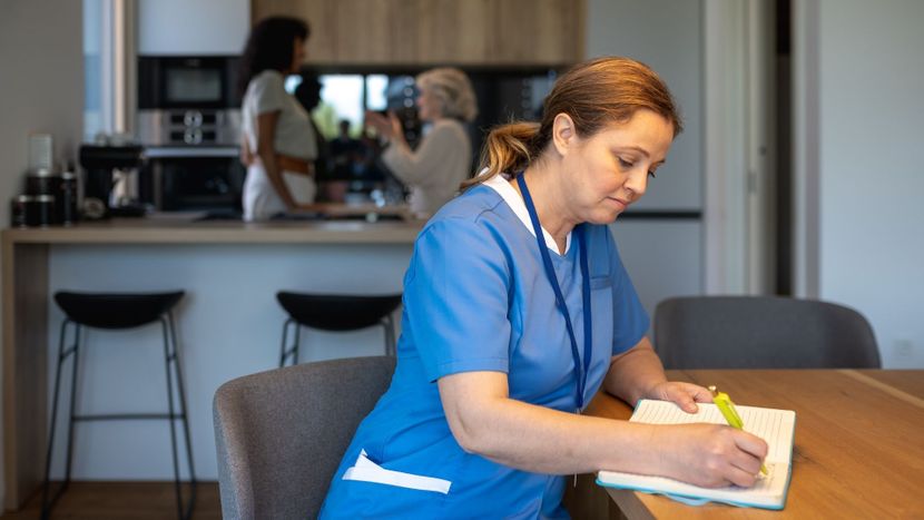 caregiver writing notes