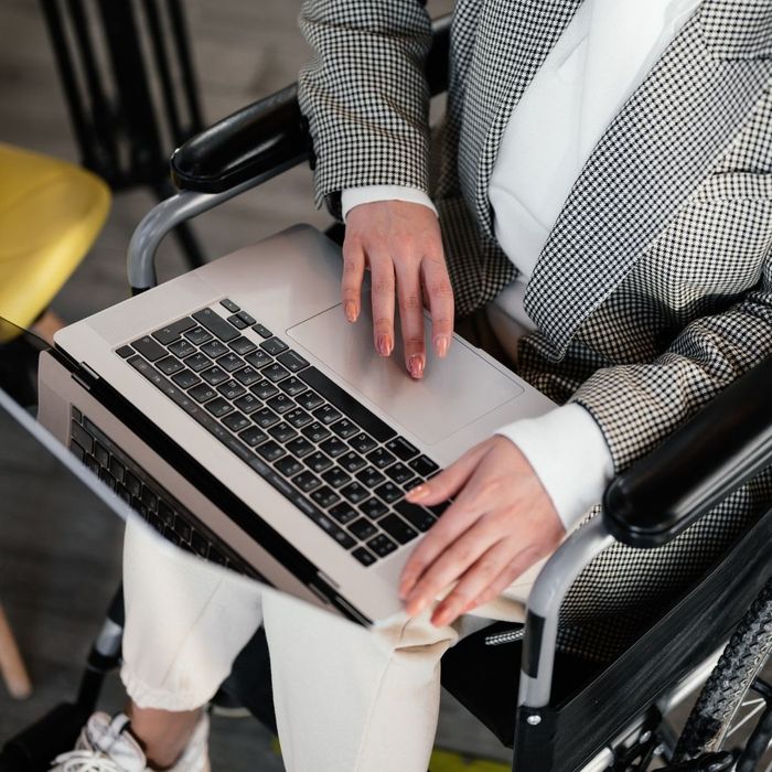 person in wheelchair using laptop