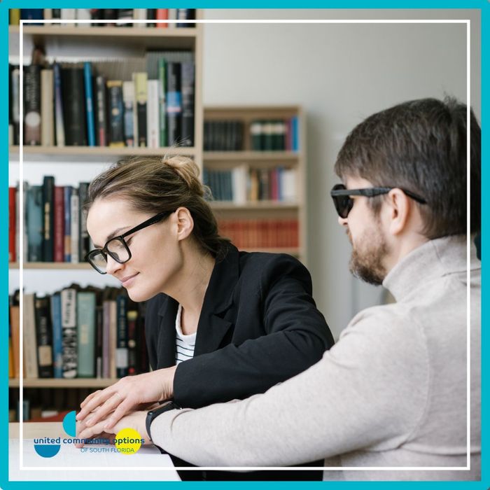 a blind man getting help reading Importance of Community (3).jpg