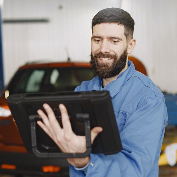 auto technician helping with insurance claim