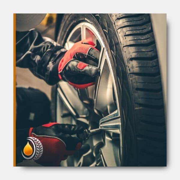 mechanic putting a tire on a car