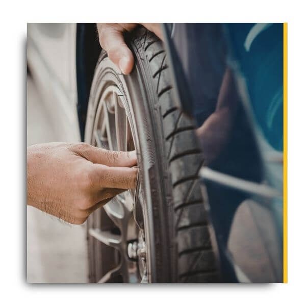 mechanic putting lug nuts on tire