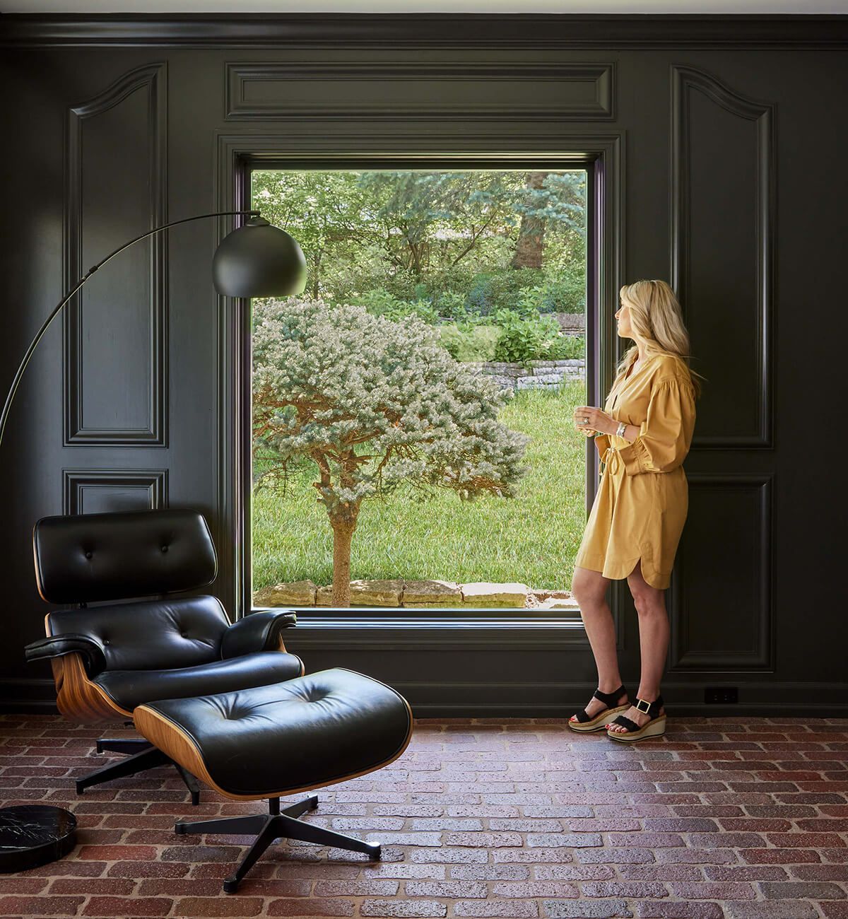 woman standing in front of large modern window woman standing in front of large modern window