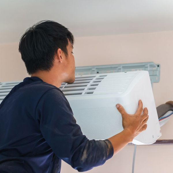 HVAC tech installs AC unit