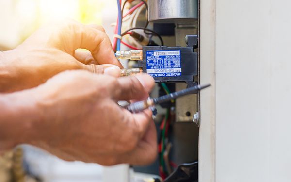 Image of a man installing an air conditioner