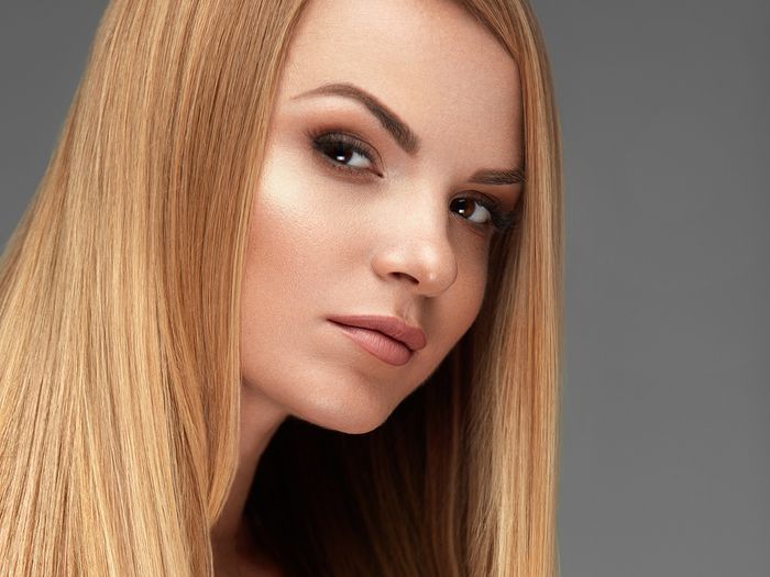 Woman with long, healthy, straight, blonde hair.