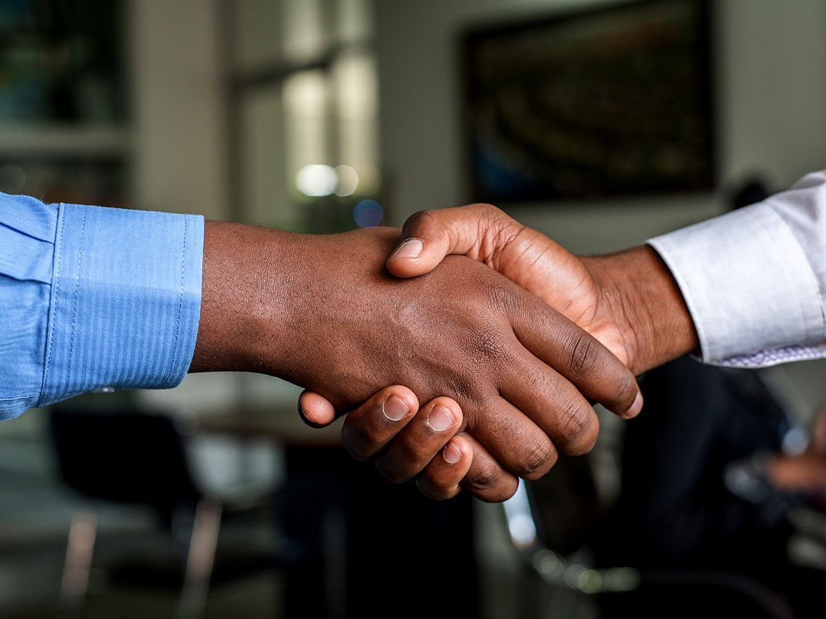 A broker and a client shaking hands.