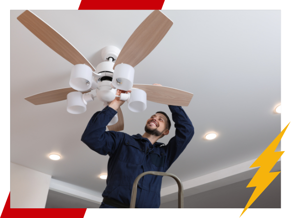 technician installing a ceiling fan