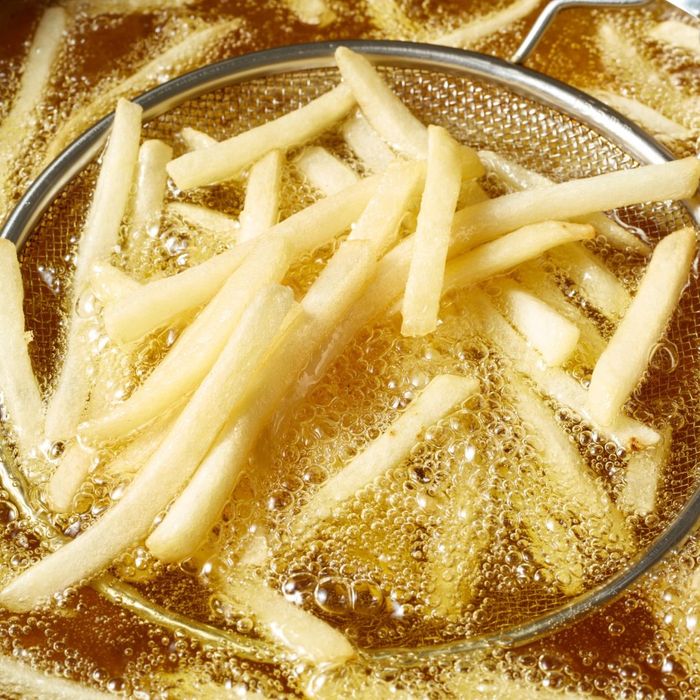 fries being cooked in a deep fryer fries being cooked in a deep fryer