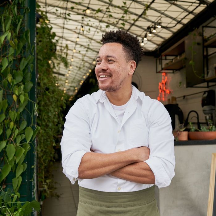 happy restaurant owner with arms folded happy restaurant owner with arms folded
