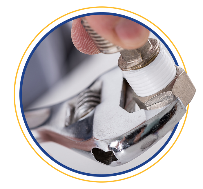 Image of a wrench tightening a bolt with plumbers tape on it